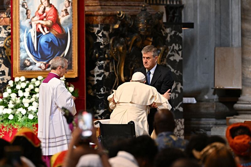 Pope Francis is helped to stand up from a wheelchair at St Peter's Basilica in the Vatican on July 3rd 