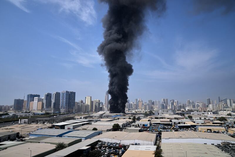 A black plume of smoke rises from a warehouse at the industrial area of Sharjah City in the United Arab Emirates, after reports of Iranian strikes in Dubai, on Sunday. Photograph: Altaf Qadri/AP
