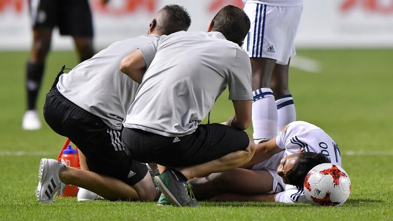 Real Salt Lake’s Sebastian Saucedo gets attention after a tackle from Antionio Valencia. Photograph: Gene Sweeney Jr/Getty