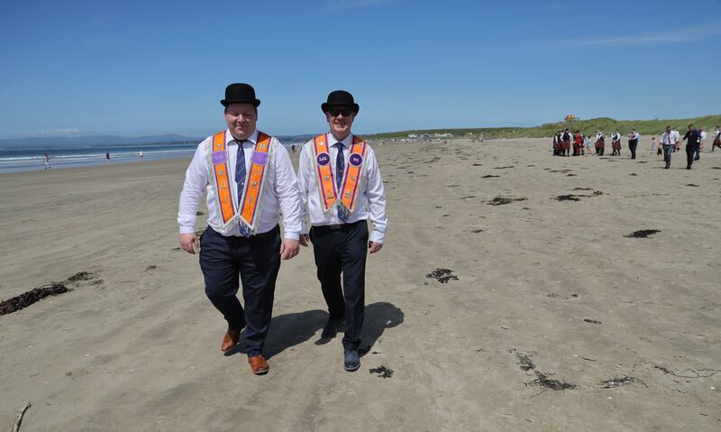David Jordan (left) and James Johnston from Derry on the beach following the Orange Order parade that took place in Rossnowlagh, Co.Donegal on Saturday. Photo: Bryan O’Brien / The Irish Times   
