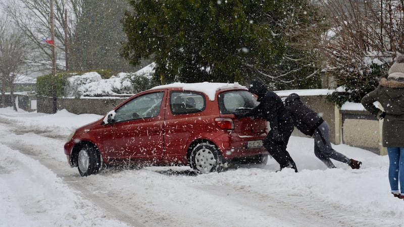 A file image from March of this year of people trying to push a car through snow in Dunboyne Co Meath. Photograph: Alan Betson/The Irish Times