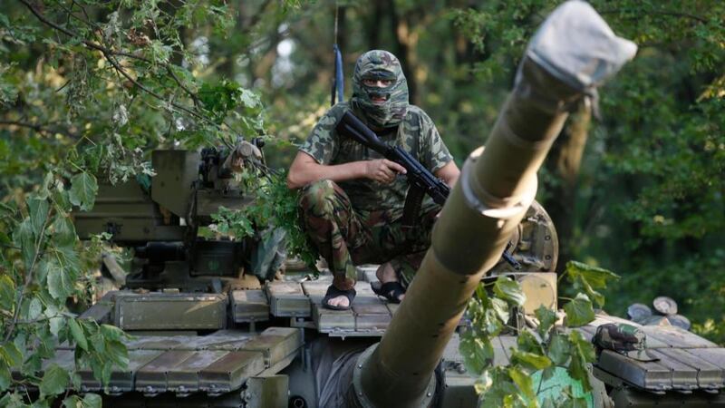 A pro-Russian separatist 
from the Vostok (East) battalion poses for a picture
atop a T-64 tank in Donetsk, eastern Ukraine, yesterday, where fighting continued to rage when separatists tried to break through the lines of government forces near the border with Russia. Photograph: Maxim Zmeyev/Reuters