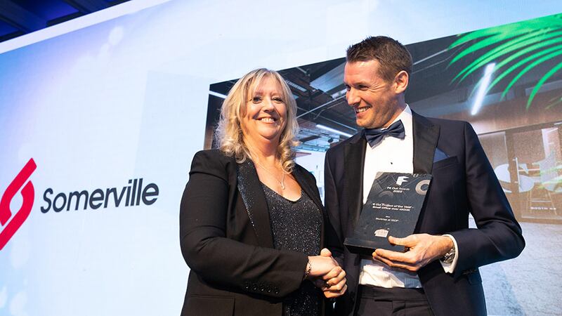 Robbie Hamilton, managing director, CRM Interior Fit-Outs, presents the Fit Out Project of the Year - Small Office over €500K award to Angela Connolly, awards judge, on behalf of Somerville Fit-Out team.