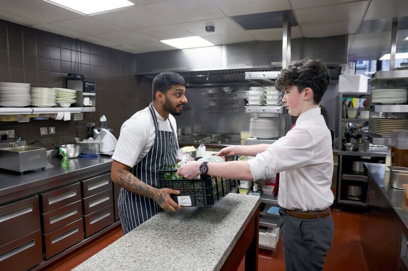 Handing over the goods: Conor O'Leary of Belvedere College delivering urban farm produce to Midhnav Manoj of Chapter One. Photograph: Enda O'Dowd