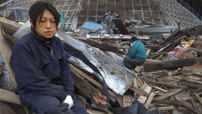 A man mourns the death of his mother after her body was discovered on March 21st, 2011 in Rikuzentakata, Japan. The death toll continues to rise with numbers of dead and missing exceeding 20,000 in a tragedy not seen since World War II in Japan. (Photo by Paula Bronstein/Getty Images)