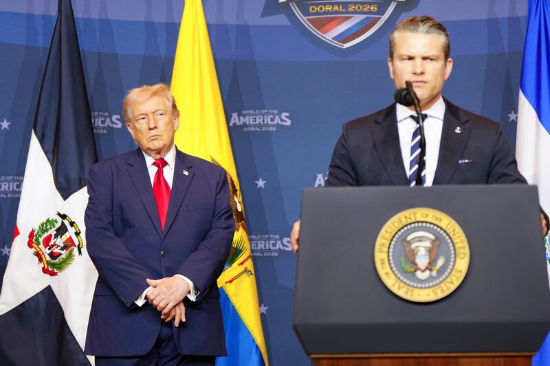 President Donald Trump watches as defence secretary Pete Hegseth speaks to attendees at the Shield of the Americas Summit, held at Trump’s golf resort in Miami on Saturday. Photograph: Tierney L. Cross/The New York Times
                      