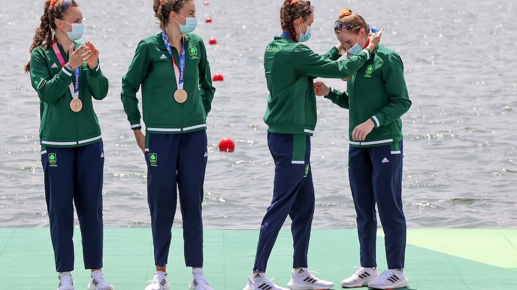 Ireland’s Aifric Keogh and Eimear Lambe watch as Fiona Murtagh presents Emily Hegarty with her bronze medal. Photo: Morgan Treacy/Inpho