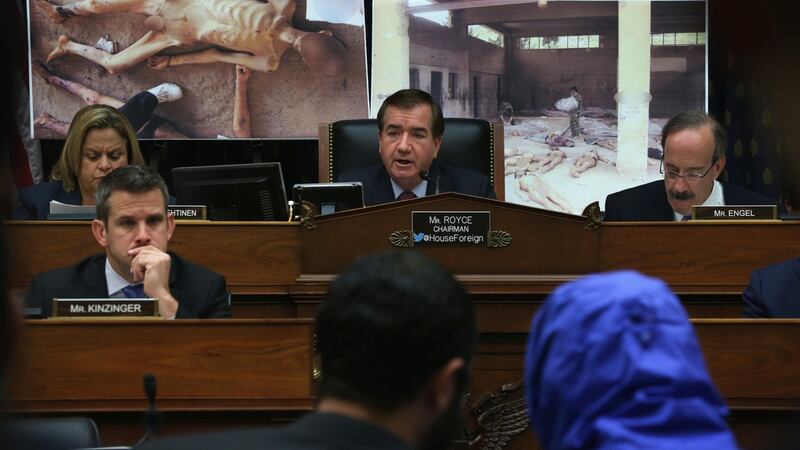 A Syrian Army defector in a blue hooded jacket during a briefing before the US House of Representatives foreign affairs committee in 2014. The defector, a former army photographer, has smuggled out of Syria more than 50,000 photographs that document the torture and death of thousands of Syrians in Bashar al-Assad’s prisons. Photograph: Alex Wong/Getty Images