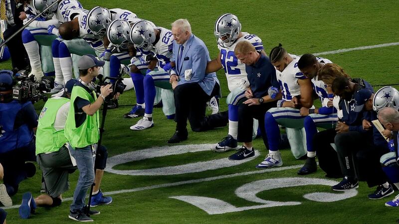 The Dallas Cowboys, led by owner Jerry Jones,  take a knee prior to the national anthem prior to an NFL football game against the Arizona Cardinals on  Monday.  Photograph: Matt York/AP