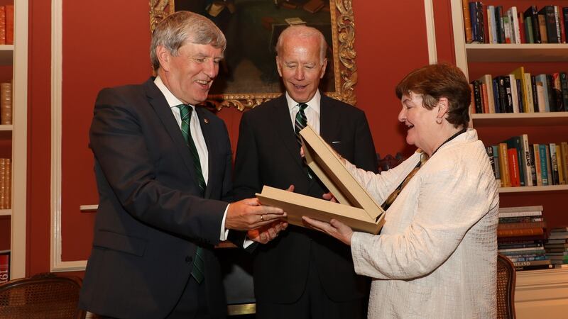Former US vice-president Joe Biden at a reception for the launch of the Cambridge History of Ireland at the Irish ambassador’s residence  in Washington on Monday, with Ambassador Dan Mulhall and Prof Bríona  Nic Dhiarmada from the University of Notre Dame, presenting Mr Biden with a special edition of a book on the Easter Rising. Photograph:  Marty Katz