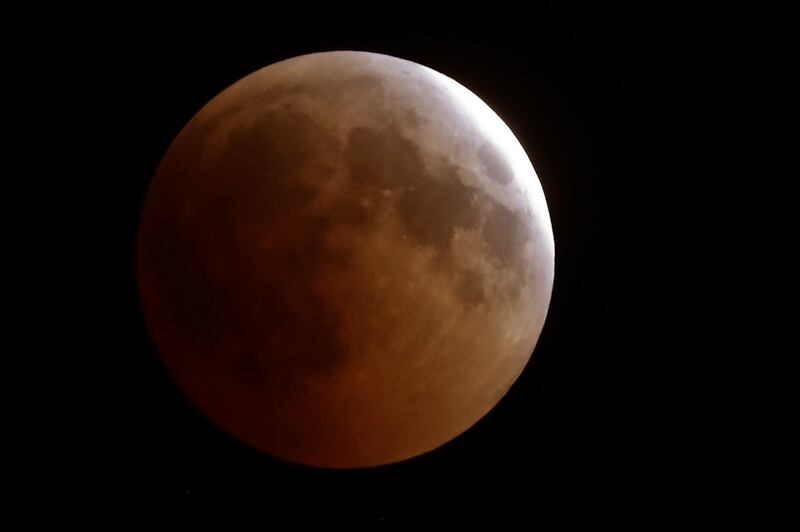 The moon in total lunar eclipse above the Lebanese town of Tannourine in the mountains north of Beirut. The longest "blood moon" eclipse this century began on July 27th, coinciding with the closest approach in 15 years by Mars.  Photograph: JOSEPH EIDJOSEPH EID/AFP/Getty Images