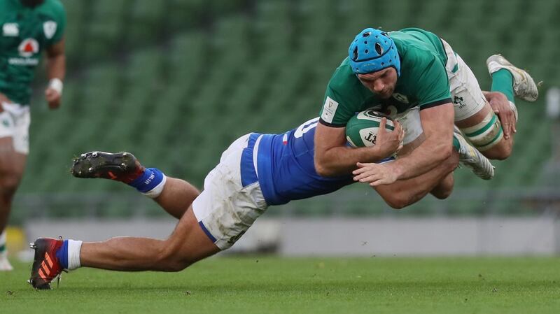 Tadhg Beirne  is tackled by Gianmarco Lucchesi of Italy.Photograph: Brian Lawless/EPA
