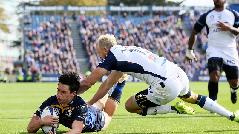 Joey Carbery scores Leinster’s  first try  despite the attentions of Montpellier’s Jesse Mogg during the  Champions Cup pool three match at The RDS Arena. Photograph: Brian Lawless/PA Wire