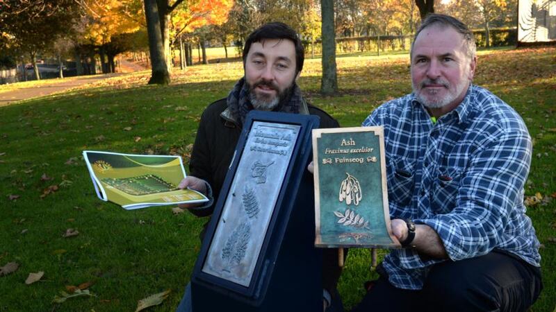 Tree trail: Sean Redmond and Donal O’Connor of Markievicz Park in Ballyfermot, west Dublin,  with tree nameplates. The original bronze plates, in O’Connor’s hands, were stolen from Bushy Park and Markievicz Park. Photograph: Cyril Byrne