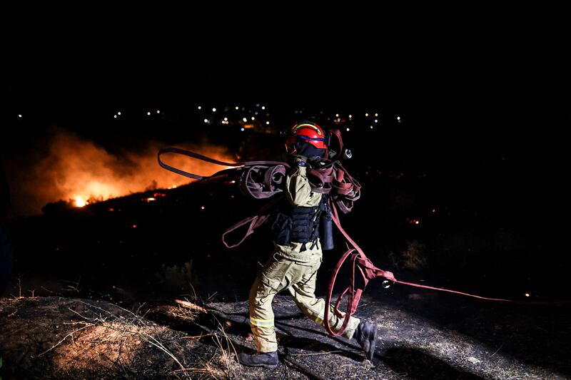 A firefighter battles a blaze in Anthousa, north of Athens. Photograph: Aris Oikonomou/AFP