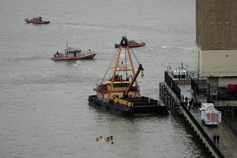 A crane vessel arrives at the scene where a helicopter crashed into the Hudson River, Thursday (Seth Wenig/AP)