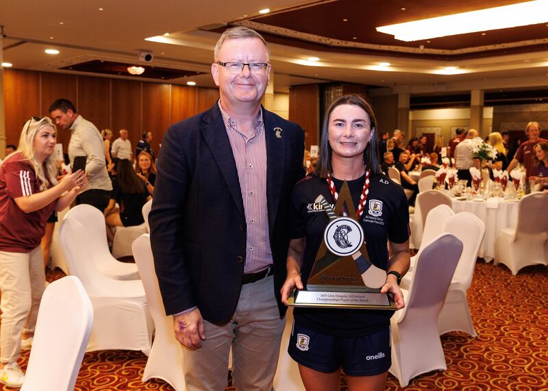 Camogie Association president Brian Molloy alongside Galway's Aoife Donohue with her Player of the Match Award. Photograph: Inpho