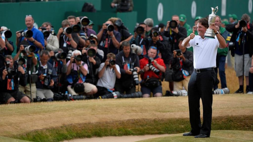 Phil Mickelson of the US smiles as he holds the Claret Jug after winning the British Open golf championship at Muirfield i. Photograph: Toby Melville/Reuters