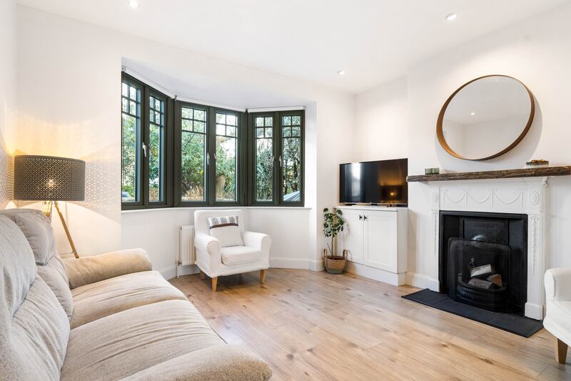 Livingroom to the front of the house has a bay window and open fire