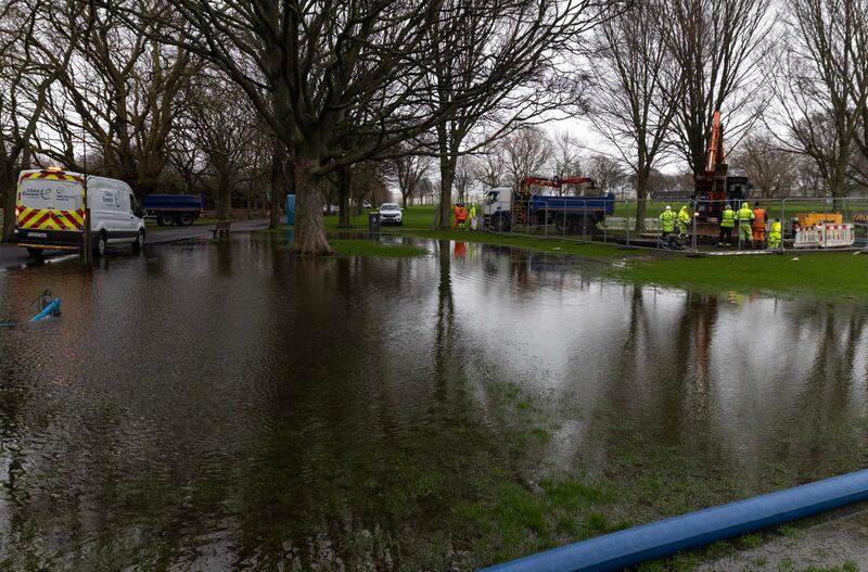 Dublin City Council and Uisce Éireann workers pump flood waters and work on repairs on Thursday morning at Fairview Park, Dublin. Photograph: Colin Keegan/Collins Dublin