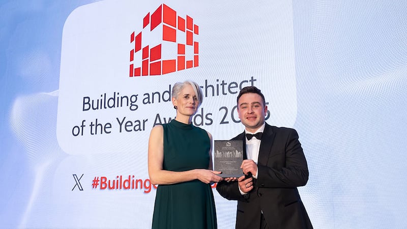 Emma Geoghegan, awards judge, presents the housing project of the year - medium award to Ben Molloy, Business River on behalf of Harcourt Technologies