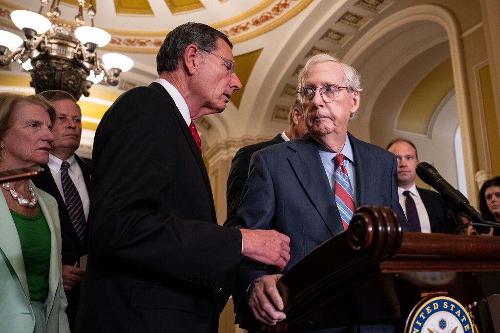 Republican senator John Barrasso reaches out to help Senate minority leader Mitch McConnell after McConnell froze and stopped talking during a news conference in Washington last week. Photograph: Drew Angerer/Getty Images