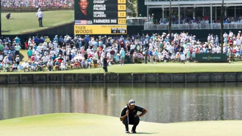Tiger Woods lines up a putt on the 17th at TPC Sawgrass. Photograph: Jamie Squire/Getty