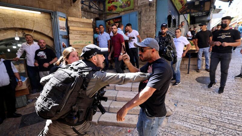 An Israeli border police member confronts a Palestinian man during protests at Damascus Gate in East Jerusalem. Photograph:   Emmanuel Dunand/AFP via Getty Images
