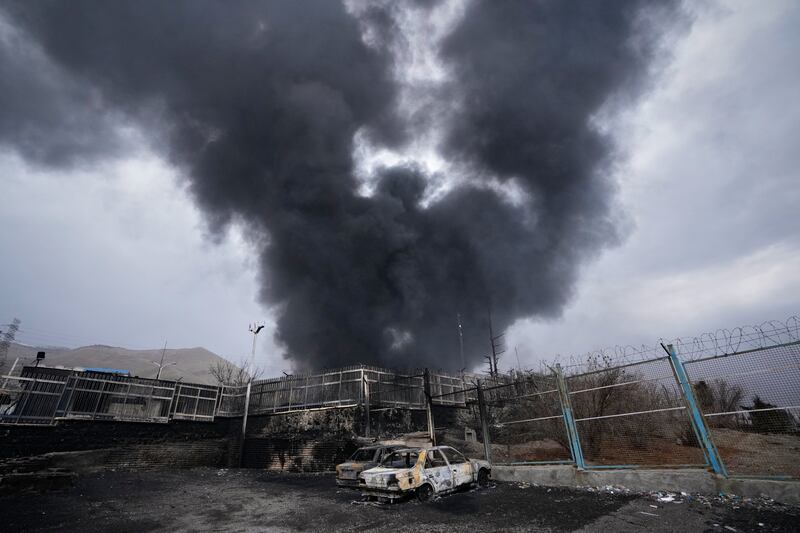 A thick plume of smoke rises from an oil storage facility hit by a US-Israeli strike in Tehran. Photograph: Vahid Salemi/AP