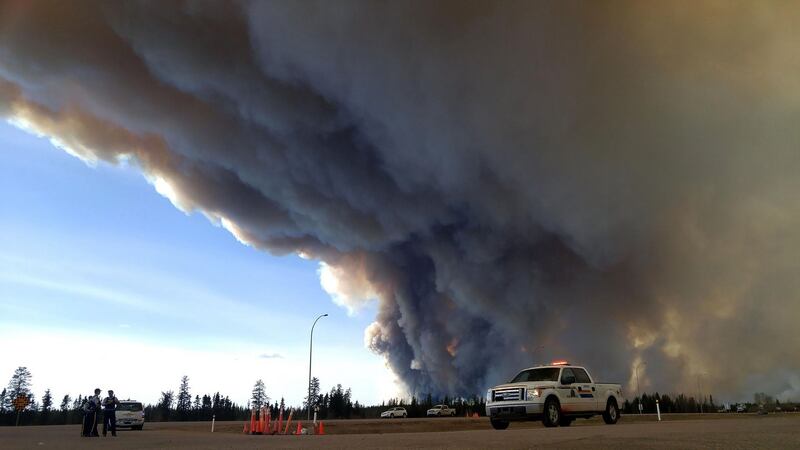 Members of the Royal Canadian Mounted Police  monitor the Fort McMurray Wildfire. Photograph: RCMP Alberta/AFP/Getty Images