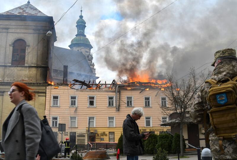 Pedestrians walk past the site of a Russian drone attack on the historic centre of Lviv on Tuesday. Photograph: Mykola Tys/EPA