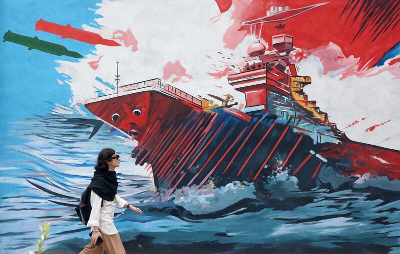 A woman walks next to anti-US imagery on a street in Tehran last week. Photograph: Abedin Taherkenareh/EPA