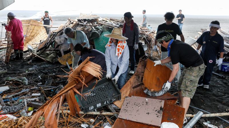 Staff trying to remove debris of a seaside house after it was destroyed by high waves on Yugawara Beach, Kanagawa prefecture, southwest of Tokyo,  on July  29th, as Typhoon Jongdari made landfall in central Japan. Photograph: Kimimasa Mayama/EPA