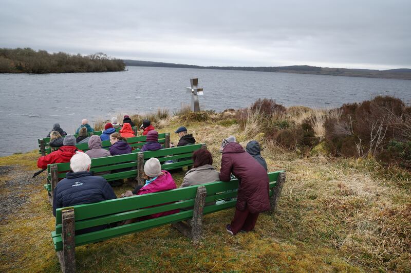 Walkers pause for a break and some food opposite Saints Island