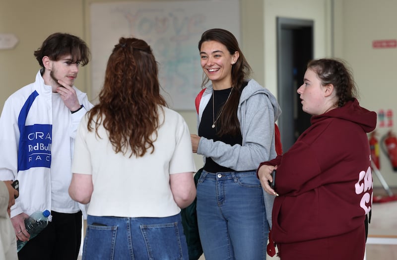 English teacher Sinead McGowan, (back to camera) with Leaving Cert students from left; Páidí Malone, Zuzanna Zoltowska and Sarah Osbourne, following English paper one at Belmayne Educate Together Secondary School, Belmayne, Dublin. Photograph: Dara Mac Dónaill