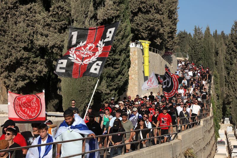 Mourners, some carrying  Hapoel Jerusalem flags, march during the funeral Hersh Goldberg-Polin on September 2nd. Photograph: Gil Cohen-Magen/AFP via Getty Images