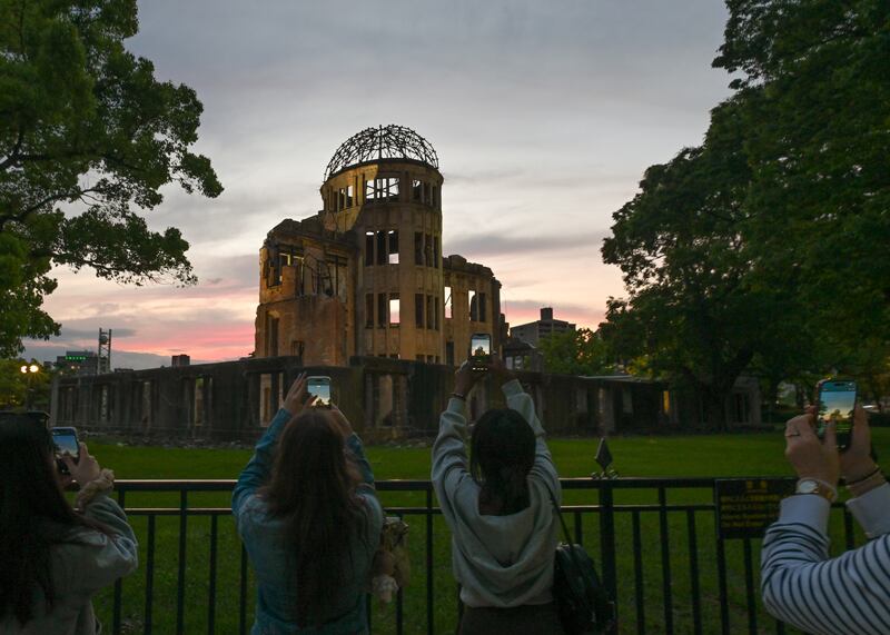 Tourists take photos of the Atomic Bomb Dome at sunset during the annual Hiroshima Flower Festival in May this year in Hiroshima, Japan. Photograph: Artur Widak/NurPhoto/Getty