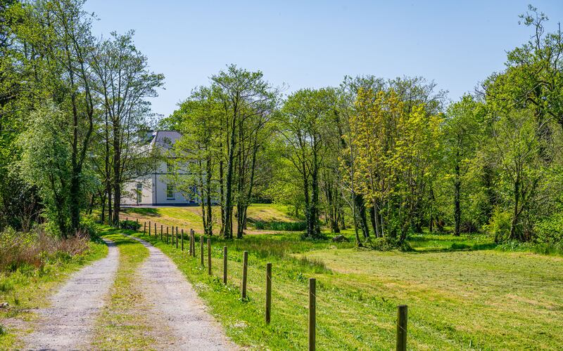 A long driveway leads up to the substantial property