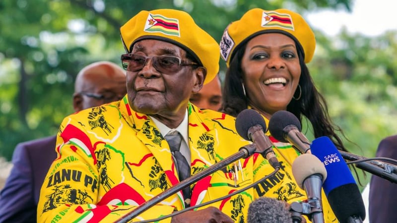 Zimbabwe president: Robert Mugabe addresses Zanu-PF members gathered to show support for his wife, Grace (right), becoming the party’s next vice-president. Photograph: Jekesai Njikizana/AFP/Getty