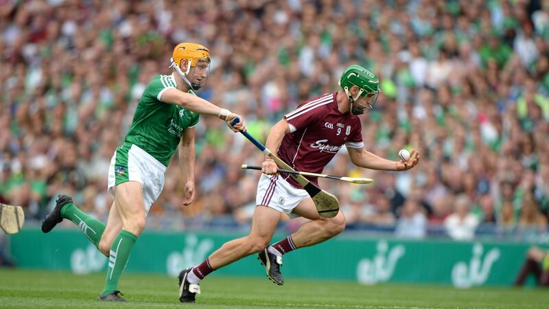 Galway skipper David Burke breaks from Limerick’s Seamus Flanagan. Photograph: Dara Mac Dónaill/The Irish Times