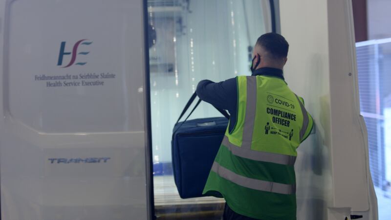 A driver loads Pfizer/BioNTech vaccines into a refrigerated van after collecting them from  the National Cold Chain Distribution Centre. Photograph: Alan Betson