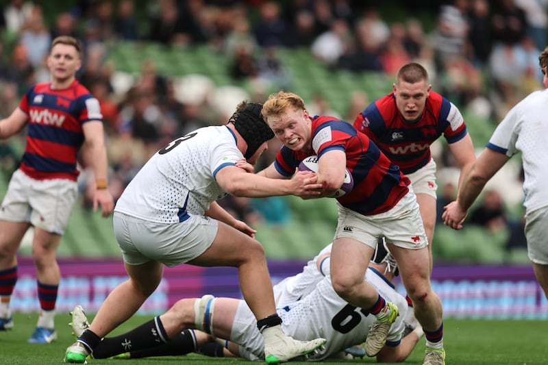 Cork's Luke Masters tries to take down Hugh Cooney of Clontarf during Sunday's AIL final. Photograph: Bryan Keane/Inpho