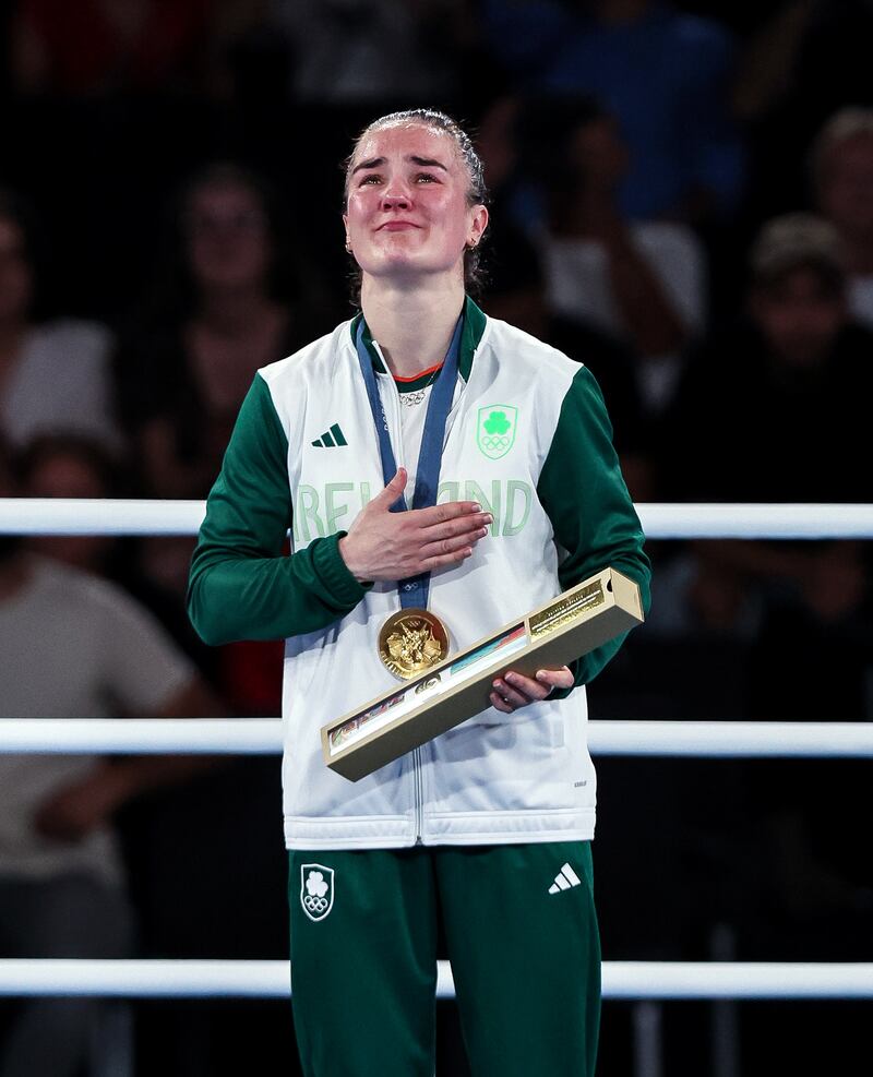 Ireland’s Kellie Harrington celebrates with her gold medal on the podium. Photo: Ryan Byrne/Inpho