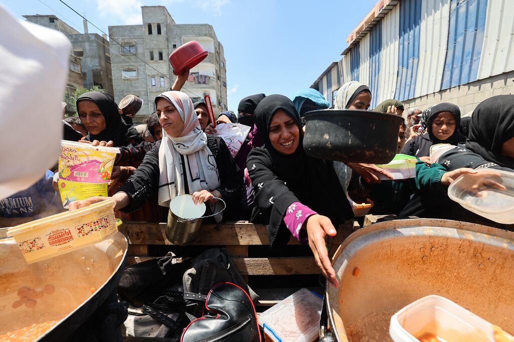 Palestinians queue for a portion of hot food distributed by a charity kitchen at the Nuseirat refugee camp in the central Gaza Strip on May 5th. Photograph: Eyad Baba/AFP via Getty Images