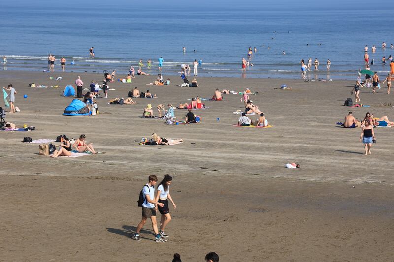 People walking, swimming and lounging in the sun at Portmarnock. Photograph: Nick Bradshaw/The Irish Times