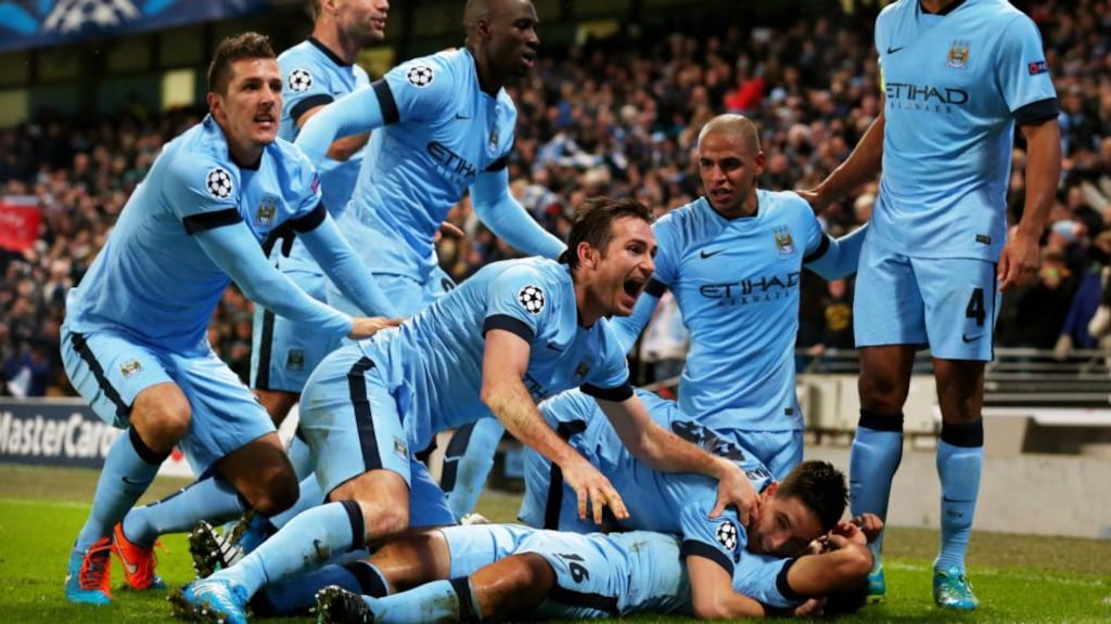 Sergio Aguero celebrates with teammates after scoring his team’s third and matchwinning goal last night. Photograph: Alex Livesey/Getty Images