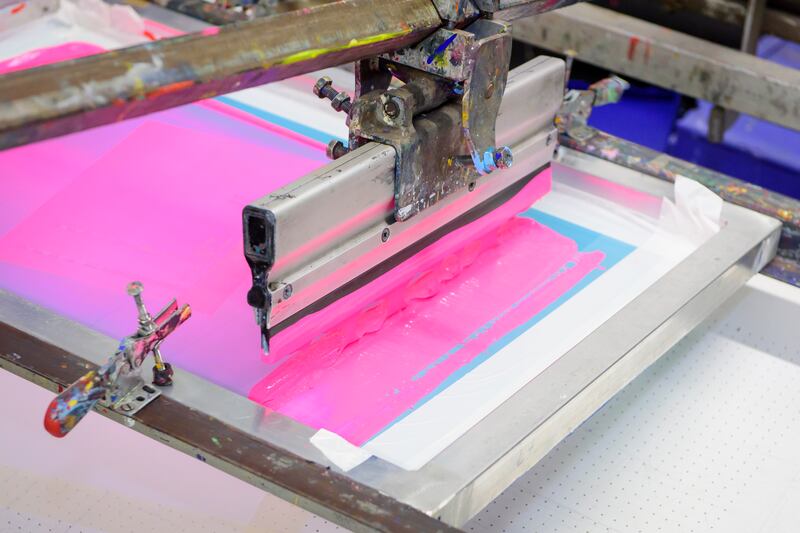 A squeegee during screen printing at Damn Fine Print. 
