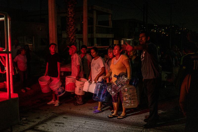 Residents line up at night to receive drinking water in Monterrey. Photograph: Cesar Rodriguez/New York Times