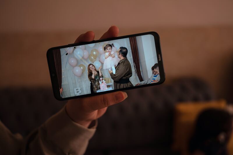 Sima Moradbeigi shows a photo of her with her husband and daughter while they lived in Iran. Photograph: Emily Garthwaite/New York Times
                      