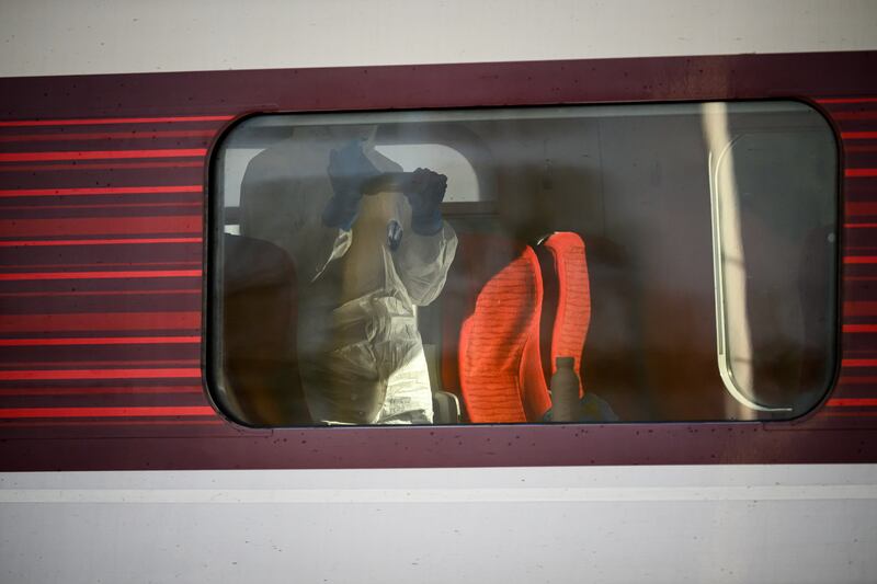A forensic investigator records evidence from inside the train at Huntingdon station on Sunday. Photograph: Leon Neal/Getty Images